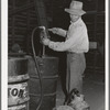 Getting gasoline from barrel at farm to take out to combine in the wheat field. Walla Walla County, Washington