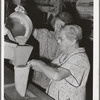 Putting samples of wheat into sack of central sampling office. Walla Walla, Washington