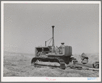 Caterpillar diesel tractor which draws combine in wheat fields on Eureka Flats. Walla Walla County, Washington