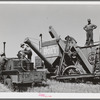 Combine and tractor are refueled in wheat field. Eureka Flats, Walla Walla County, Washington. Three men operate the tractor and combine