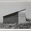Bulk wheat elevator on farm. This elevator was built from plans drawn up and furnished by the State Extension Service and AAA (Agricultural Adjustment Administration). These farm elevators are designed to take care of the bumper crop of wheat this year