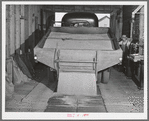 Wheat being emptied from truck into bin of wheat elevator. Eureka Flats, Walla Walla County, Washington