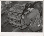 Repairing caterpillar tractor in repair shop at Colfax, Washington