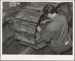 Repairing caterpillar tractor in repair shop at Colfax, Washington