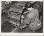 Repairing caterpillar tractor in repair shop at Colfax, Washington