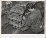 Repairing caterpillar tractor in repair shop at Colfax, Washington