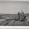 Caterpillar-drawn combine working in the wheat fields of Whitman County, Washington