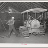 Wheat farmer starts his caterpillar tractor with aid of rope. Whitman County, Washington