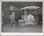 Wheat farmer starts his caterpillar tractor with aid of rope. Whitman County, Washington