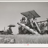 Tractor-drawn combine. Whitman County, Washington. Notice that wheat is sacked on combine