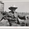 Driver of caterpillar tractor which draws combine in wheat fields of Whitman County, Washington
