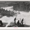 Indians fishing for salmon at Celilo Falls, Oregon. At the present time Indians have by treaty exclusive right for fishing in Columbia River which is adjacent to their reservation. This right is now being contested in lawsuits