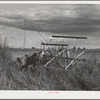 Binder stands outside because of lack of storage space on farm of FSA (Farm Security Administration) rehabilitation borrower who rents from Indian. Yakima County, Washington