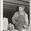 Worker on stationary mechanical hop picker. Yakima County, Washington