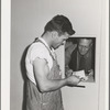 Farm worker getting mail at the FSA (Farm Security Administration) farm family migratory labor camp. Yakima, Washington. At this camp the post office was combined with the Washington State employment service office and in this way the state employment