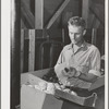 Farm worker practicing wrapping apples in the apple wrapping school at the FSA (Farm Security Administration) farm family migratory labor camp. Yakima, Washington