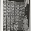 Putting labels on cases of canned salmon at the Columbia River Packing Association. Astoria, Oregon. This plant put up more than 125,000 cases of salmon in the first five days of the phenomenal salmon run this fall