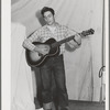 Singing cowboy songs at entertainment at the FSA (Farm Security Administration) mobile camp for migratory farm workers. Odell, Oregon