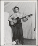 Singing cowboy songs at entertainment at the FSA (Farm Security Administration) mobile camp for migratory farm workers. Odell, Oregon