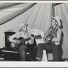 Singing cowboy songs at entertainment at the FSA (Farm Security Administration) mobile camp for migratory farm workers. Odell, Oregon