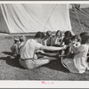 Repairing bicycle. FSA (Farm Security Administration) mobile camp for migratory farm workers. Odell, Oregon