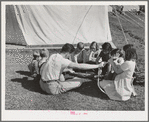 Repairing bicycle. FSA (Farm Security Administration) mobile camp for migratory farm workers. Odell, Oregon