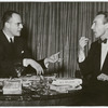 Lincoln Kirstein and George Balanchine talking while seated at a table