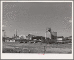 Warehouses and elevators on the waterfront of Astoria, Oregon. Fish and by-products, grain and lumber are shipped from this part