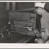 Salmon butcher. Columbia River Packing Association, Astoria, Oregon. During the peak of the run there were 150 butchers working in this plant. Townspeople, CCC (Civilian Conservation Corps) boys, and furloughed soldiers helped out