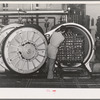Putting trays of canned salmon into ovens for cooking. Columbia River Packing Association, Astoria, Oregon