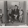 Workman at Umatilla ordnance depot and his children in homemade trailer. Stanfield, Oregon