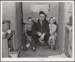 Workman at Umatilla ordnance depot and his children in homemade trailer. Stanfield, Oregon