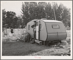 Workman at Umatilla ordnance depot and his children in homemade trailer. Stanfield, Oregon