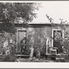 Workman at Umatilla ordnance depot, in front of house which is a converted woodshed and which he shares with another workman. Hermiston, Oregon