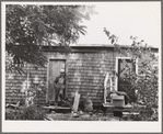 Workman at Umatilla ordnance depot, in front of house which is a converted woodshed and which he shares with another workman. Hermiston, Oregon