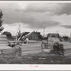 Sawing lumber to length for construction of sanitary units at the FSA (Farm Security Administration) trailer camp at Stanfield, Oregon. This camp will provide some housing for workmen at the Umatilla ordnance depot