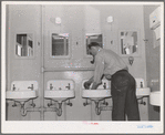 Workman at Navy shipyards, Bremerton, Washington, in the washroom at the FSA (Farm Security Administration) dormitories