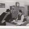 Workman at the Navy shipyards, Bremerton, Washington, talks with the manager of FSA (Farm Security Administration) duration dormitory about a room