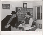 Workman at the Navy shipyards, Bremerton, Washington, talks with the manager of FSA (Farm Security Administration) duration dormitory about a room