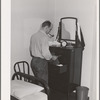 Workman at the Navy shipyards, Bremerton, Washington, in his room at the FSA (Farm Security Administration) duration dormitories. Bremerton, Washington