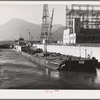 Boat and gasoline barge in navigation locks. Bonneville Dam, Oregon