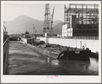 Boat and gasoline barge in navigation locks. Bonneville Dam, Oregon