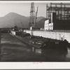 Boat and gasoline barge in navigation locks. Bonneville Dam, Oregon