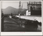 Boat and gasoline barge in navigation locks. Bonneville Dam, Oregon