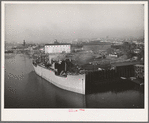 Oceangoing boat being loaded with lumber at Portland, Oregon