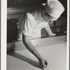 Tillamook cheese plant. Tillamook County, Oregon. Workman determining degree of progress in curdling milk