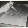 Breaking up curdling milk is one of the first steps of cheesemaking. Tillamook cheese plant, Tillamook, Oregon. This also distributes evenly the lactic ferment starter