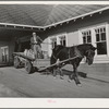 Dairy farmer takes home his empty milk cans from the Tillamook cheese plant. Tillamook, Oregon