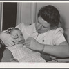 FSA (Farm Security Administration) nurse examines the teeth of migrant in the FSA dental trailer at the FSA camp for farm workers. Caldwell, Idaho