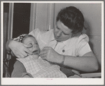 FSA (Farm Security Administration) nurse examines the teeth of migrant in the FSA dental trailer at the FSA camp for farm workers. Caldwell, Idaho